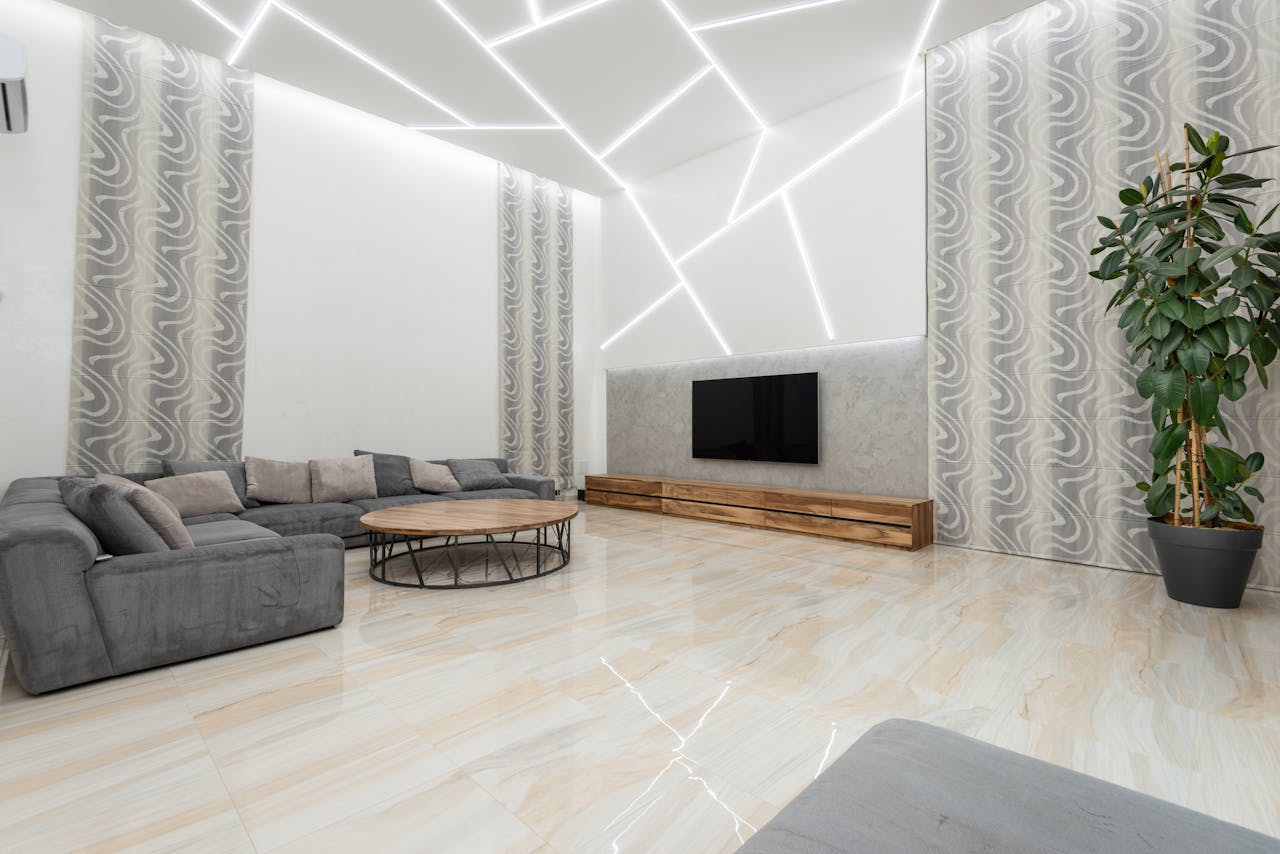 Spacious, contemporary living room with unique lighting and modern decor.
